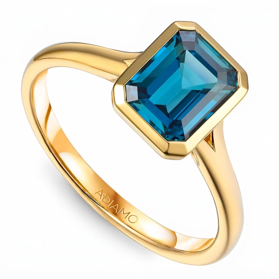 Pierścionek z żółtego złota z london blue topazem w szlifie szmaragdowym - 1,89ct
